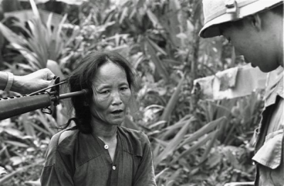 a-female-viet-cong-suspect-is-questioned-at-gunpoint-by-a-south-vietnamese-national-police-officer-1967