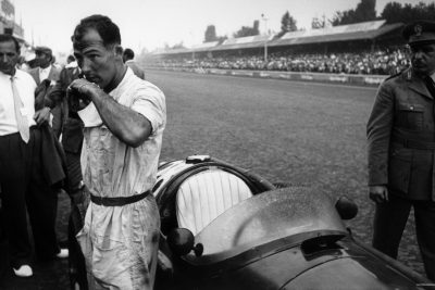 stirling-moss-stands-by-his-car-ahead-of-the-race-italian-grand-prix-monza-september-5-1954